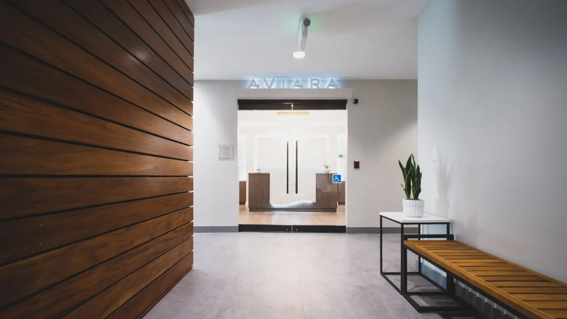 The Aviara entry, with a warm wood wall and the Aviara name over the glass doors