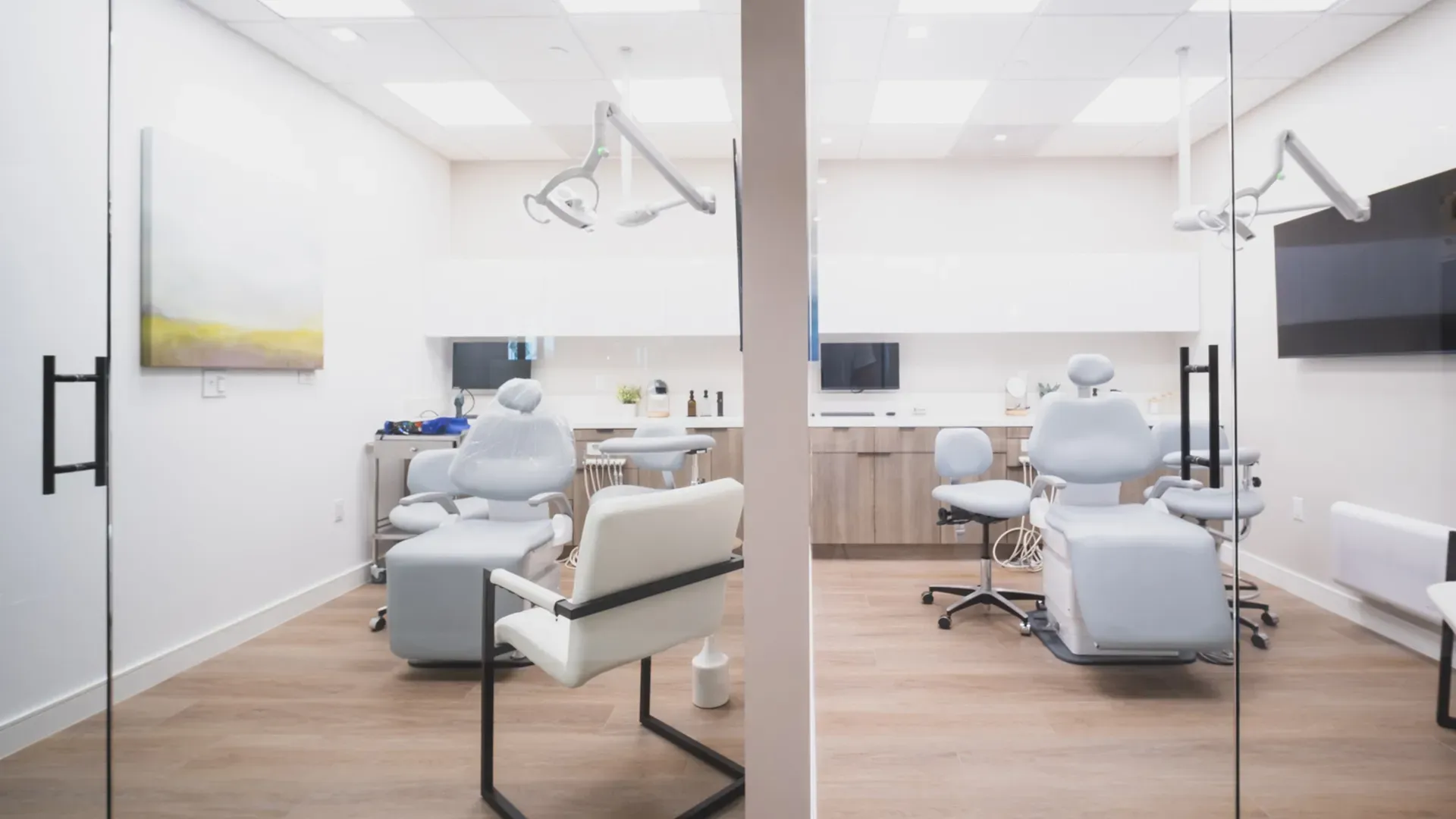 Two treatment chairs in a bright, glass-walled room